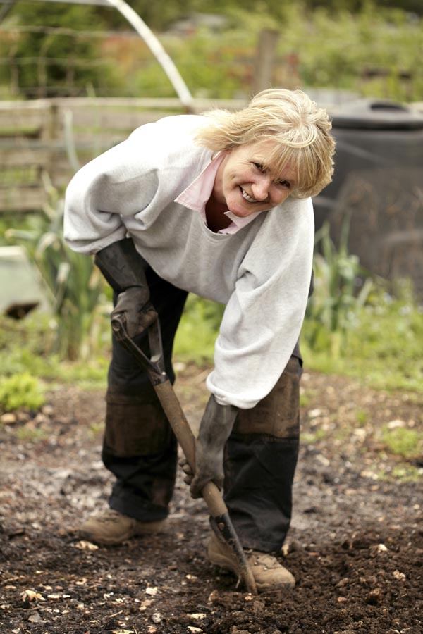 Lady shovelling soil