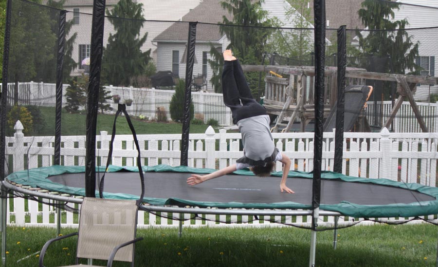 Boy jumping on trampoline