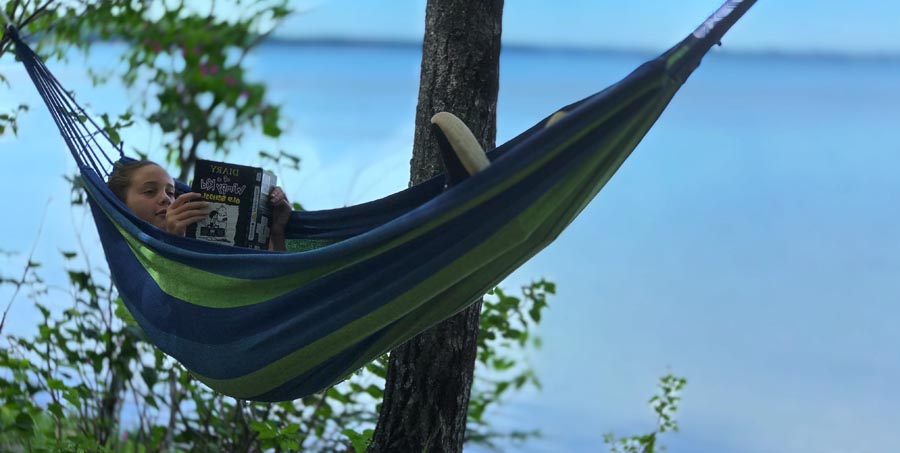 Girl in hammock reading book