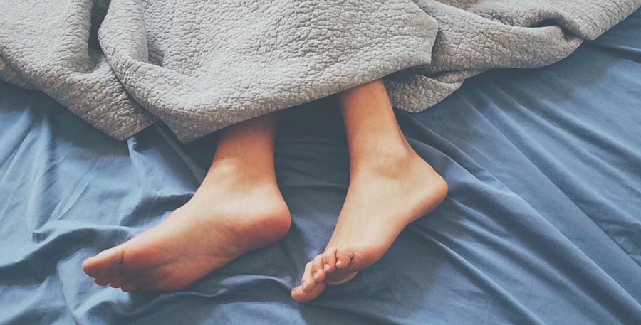 Feet coming out from blanket