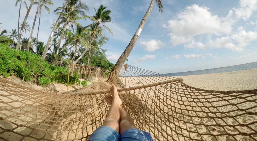 Person on hammock with sea in background
