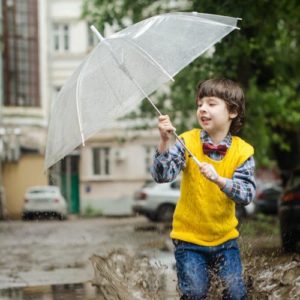 Child with umbrella jumping