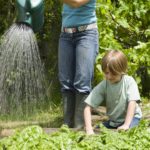 Boy gardening with mother