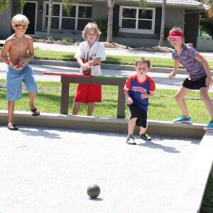 Children looking excited playing Bocce Ball