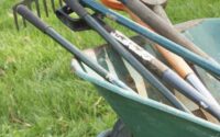 Range of gardening tools in wheelbarrow