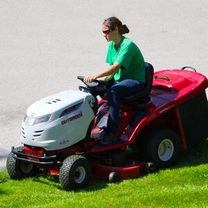 Lady driving riding mower