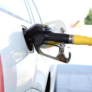 Car with nozzle of pump in gas tank