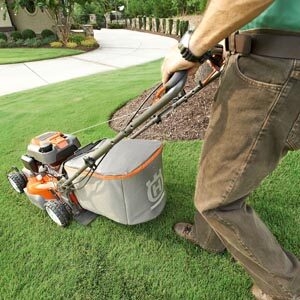 Man pushing mower