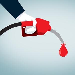 Hand Holding Red Nozzle Pumping Gas - Fossil Fuel - Oil and Petr
